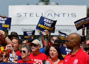 UAW members participate in a rally outside the Stellantis Sterling Heights Assembly Plant in Sterling Heights, Michigan, US, on Friday, Aug. 23, 2024. UAW members are participating in an informational rally after UAW locals representing tens of thousands of Stellantis workers filed grievances with the company over their failure to "Keep the Promise" made in contract negotiations in 2023, according to the organizers.